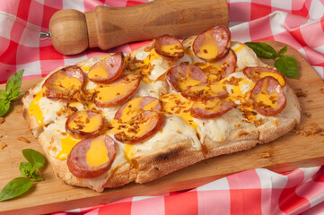 pizza with cream sauce with smoked sausage and cheddar sauce