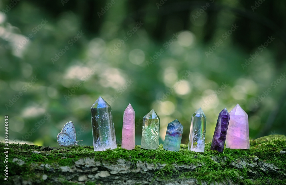 Wall mural minerals and butterfly close up on abstract forest natural background. quartz towers for esoteric ma