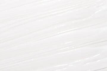 Obraz premium A creamy cosmetic background with smeared cream white. Cream texture full screen