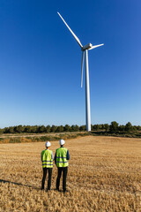 Engineers working in a wind turbine field.