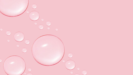 Drops of transparent gel or water in different sizes. On a pink background.