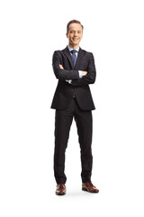 Full length portrait of a businessman standing with folded arms and smiling