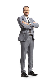 Full length shot of a businessman standing with folded arms and smiling