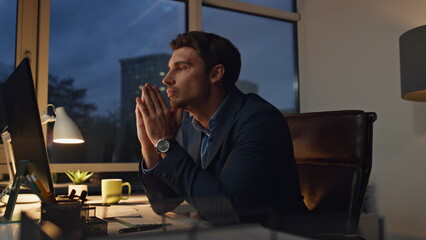 Concerned manager working late in office. Thoughtful businessman look solution