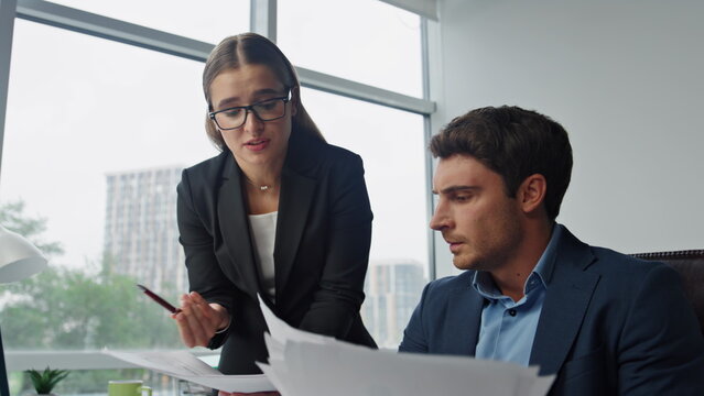 Nervous worker reporting boss in office. Angry executive shouting throw papers