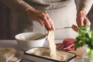 Chef preparing beef Argentinian milanesas.