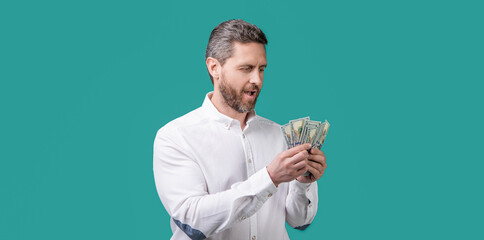 amazed businessman earning money in studio. businessman hold money earning
