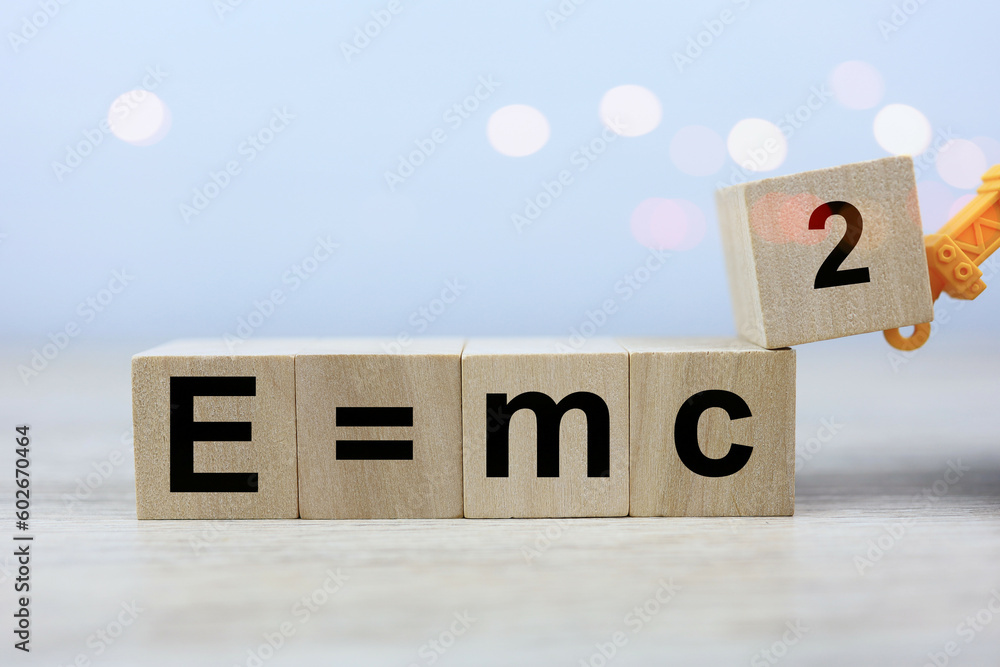 Wall mural the albert einstein physics equation is e equals m c squared in a wooden block of dice. physics educ