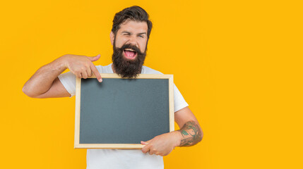 winking bearded man presenting sale isolated on yellow banner. man presenting sale on background