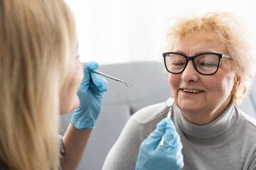 Close up portrait of elderly beautiful woman check up and having the consultation with dentist at...