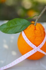 beautiful, juicy, ripe oranges lie on the table, a charge of vitamin and energy. the picture reproduces the theme of weight loss