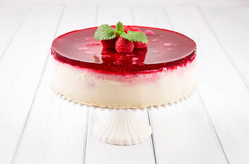 Traditional German cheesecake with cherry and raspberry served as close-up on a cake plate