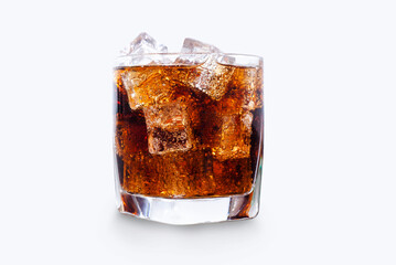 Glass of refreshing cola with ice on white table