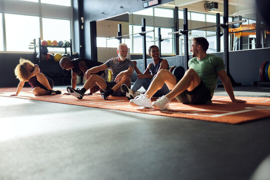 Diverse people talking on a gym floor