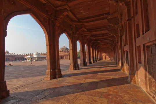 Arched pillars carved in red sandstone at Fatehpur Sikri, India.