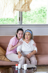 Asian young woman take care and  support with hug, that make feel good and smile older mother in...