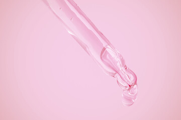 Leaking transparent gel from an eyedropper onto a pink background. Bubbles from the gel. Gel texture.