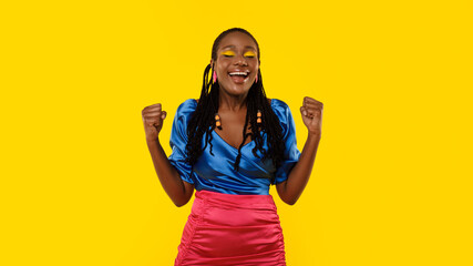 African American Lady Gesturing Yes Celebrating Victory Over Yellow Background