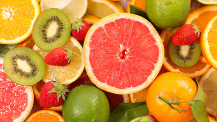 Fototapeta na wymiar assortment of slices of fresh fruits- grapefruit, kiwi,strawberry and orange - healthy eating- healthy eating