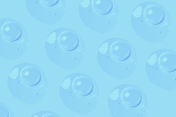 round drops of transparent gel serum on a blue background. gel with bubbles. Water droplets