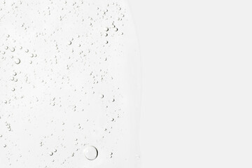 The texture of the serum or gel. Transparent cream with bubbles in the background. Transparent cosmetic gel in close-up. .Oxygen bubbles. .