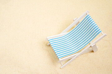Fototapeta na wymiar Vacation, beach, travel, relaxation concept. background with blue beach chair on the sand. Minimalism with copy space