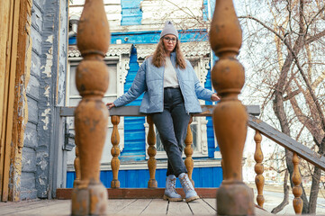 Fototapeta na wymiar Portrait of a stylish woman in blue jacket. Spring outdoor portrait.