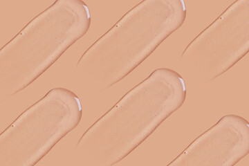 A set of strokes of transparent gel on a beige background.