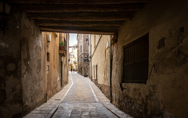 Calaf (Anoia), Catalunya, Spain - May 14, 2023: Narrow cobblestone street