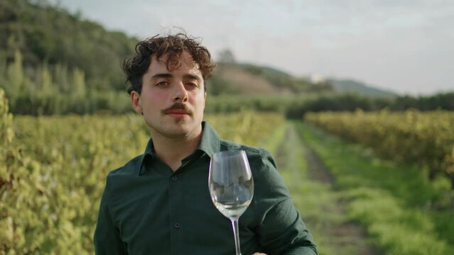 Winegrower drinking wine vineyard close up. Sommelier tasting delicious alcohol.
