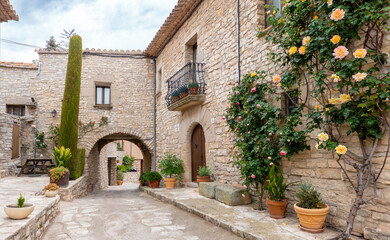 Fototapeta na wymiar L'Astor (Anoia), Catalunya, Spain - May 14, 2023: Stone houses in the medieval village