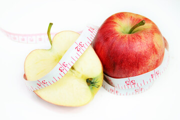 Measurement tape wrapped around red apple - health, diet