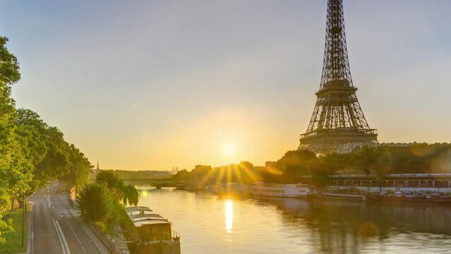 Eiffel Tower and the Seine river at Sunrise panoramic timelapse, Paris, France. Morning view from Bir-Hakeim bridge with reflections on water and traffic on the street