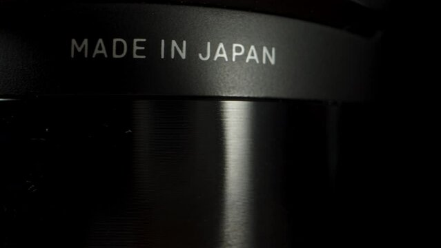 A label on the device indicating it is made in Japan, rotating in close-up on a black background.
