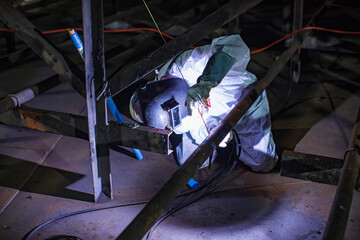Welding arc argon worker male repaired metal is welding sparks industrial construction