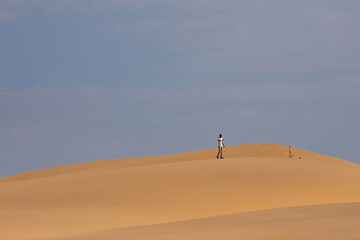Fototapeta na wymiar person walking through the Namib desert