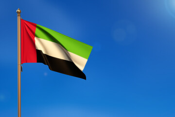 United Arab Emirates. Flag blown by the wind with blue sky in the background