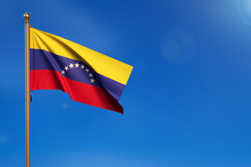 Venezuela. Flag blown by the wind with blue sky in the background