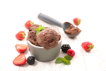 chocolate ice cream scoop in bowl with fresh berries fruits