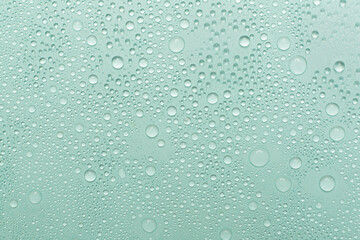 Water drops on color background, top view