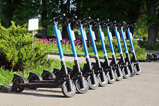 Row of electric scooters parked in the city.