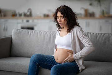 Braxton Hicks Contractions. Young Pregnant Woman Having Abdominal Pain At Home