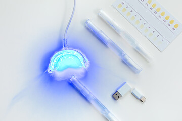 teeth whitening kit at home with LED lamp, on a white background, snow-white smile, dental care,...