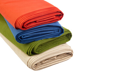Multi-colored rolls of fabric on a white background