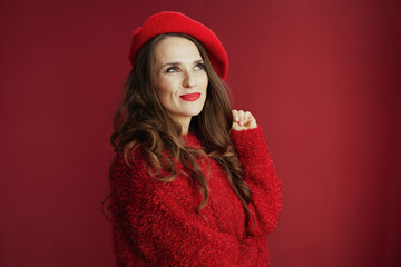 pensive trendy female in red sweater and beret