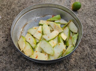Mango slices with red chili and salt