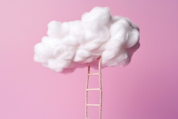 A white cotton cloud with a rope ladder going down on pink background Y2K style © Cinematic Stock