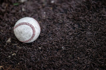Baseball sitting on a baseball field