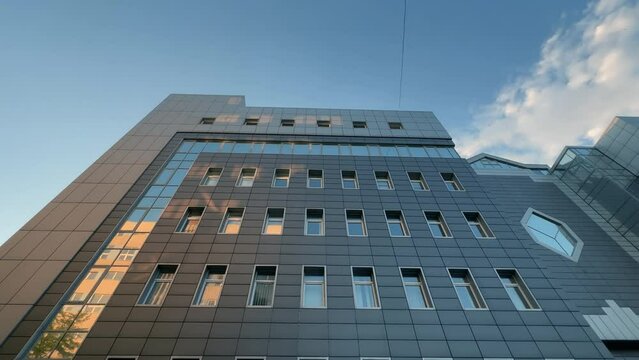 Modern factory office building exterior covered with metal building cladding. Low wide angle shot