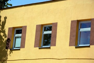 Fototapeta na wymiar Low block building built of red brick with narrow windows